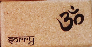 Close-up Cork Yoga Block with OM symbol and "Sorry" inscripstion