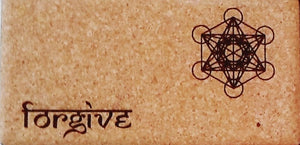 Close-up Cork Yoga Block with Yantra and "Forgive" inscripstion