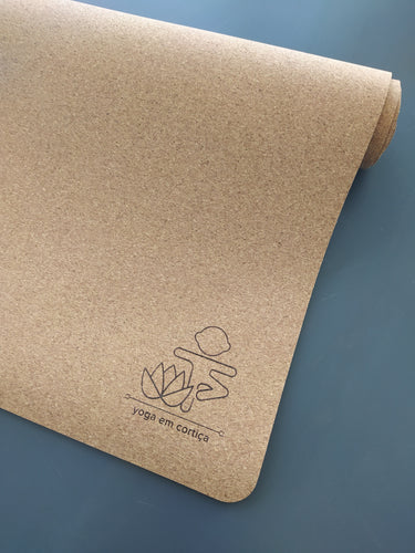 Cork Yoga Mat for Kids, with  a logo depicting a lotus flower and a kid doing vrikshasana